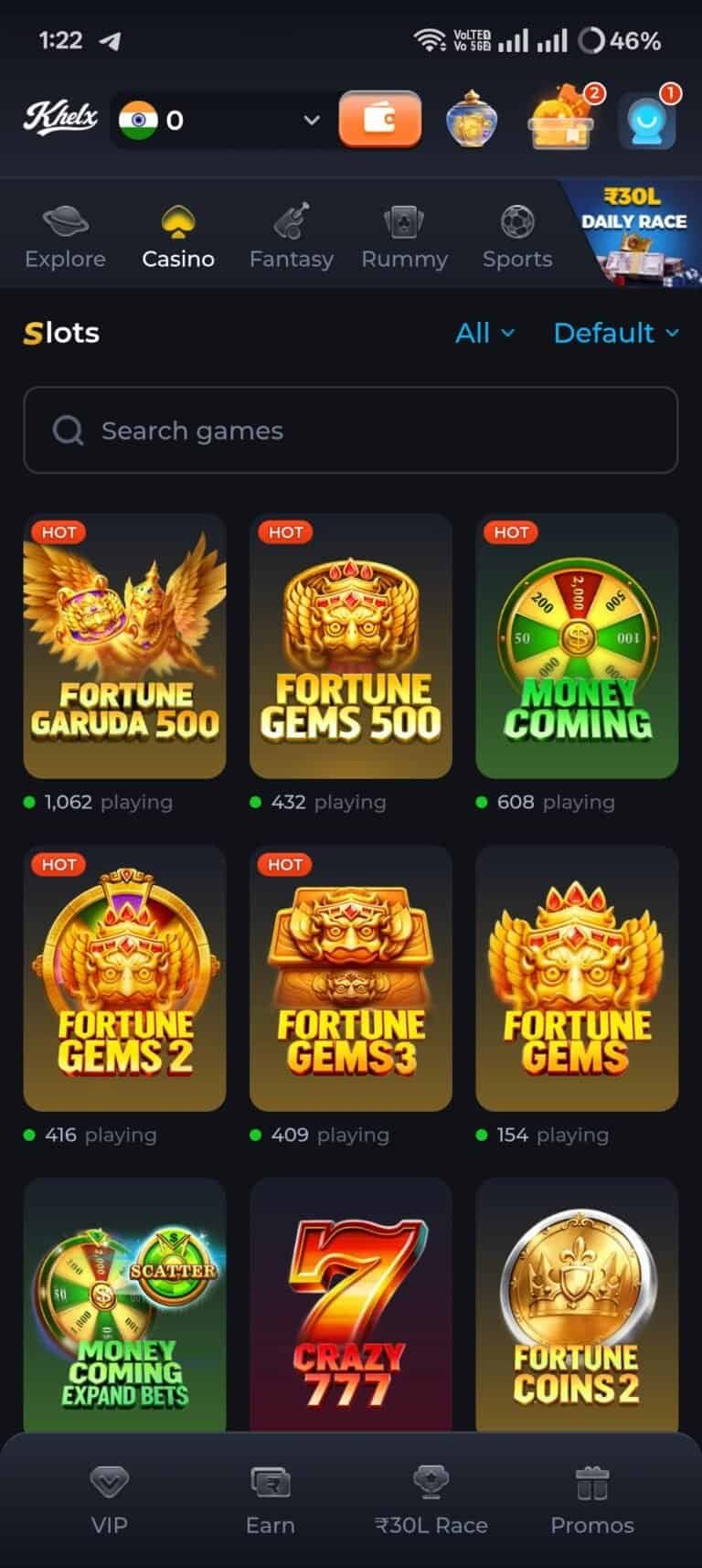 Khelx Game interface showing the Slots lobby. The screen displays a search bar and a grid of popular casino slot titles including Fortune Garuda 500, Fortune Gems 500, Money Coming, Crazy 777, and Fortune Coins 2. Several games have 'HOT' tags and show active player counts.